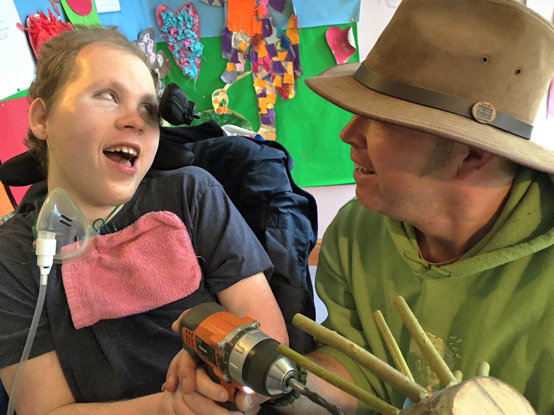 A person in care making a wildwood craft project